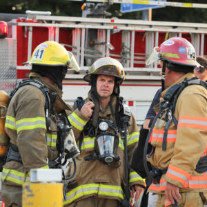 Image of two firefighters getting instructions from captain.