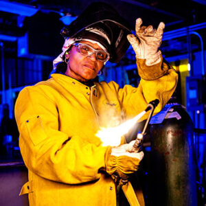 woman welder with fire